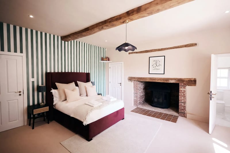 Large bedroom with fireplace in onsite accommodation at Copdock Hall