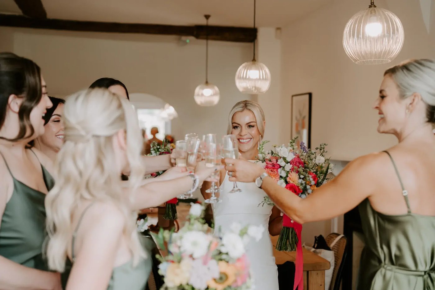 Bride and bridesmaids having a toast before the wedding at Copdock Hall