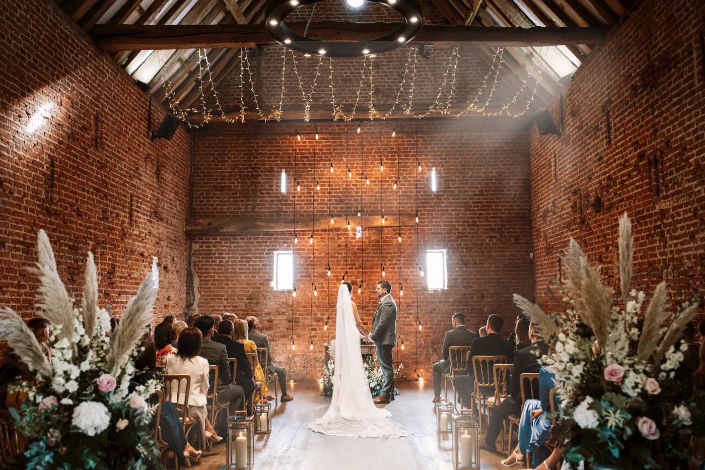 Bride and groom being wed in the barn at Copdock Hall