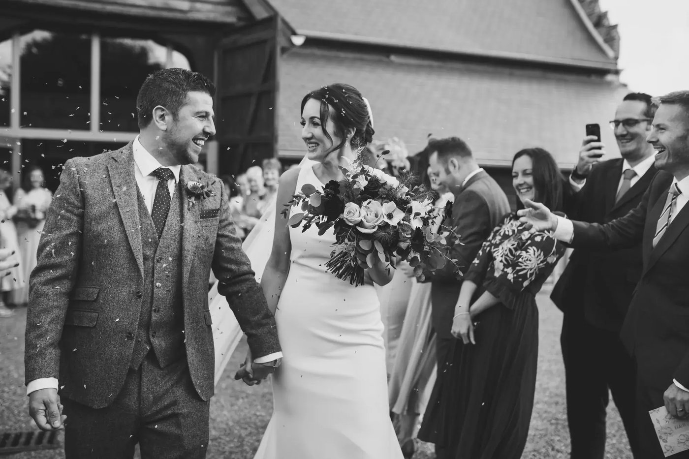 Couple walking out of the venue after being wed at Copdock Hall