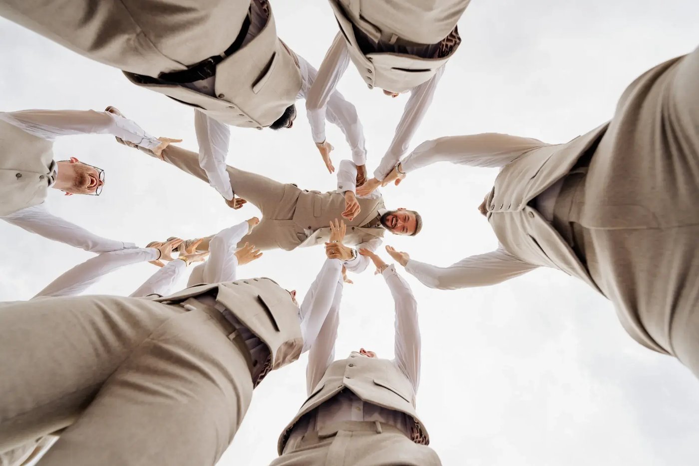 Groomsmen throwing groom in the air at Copdock Hall