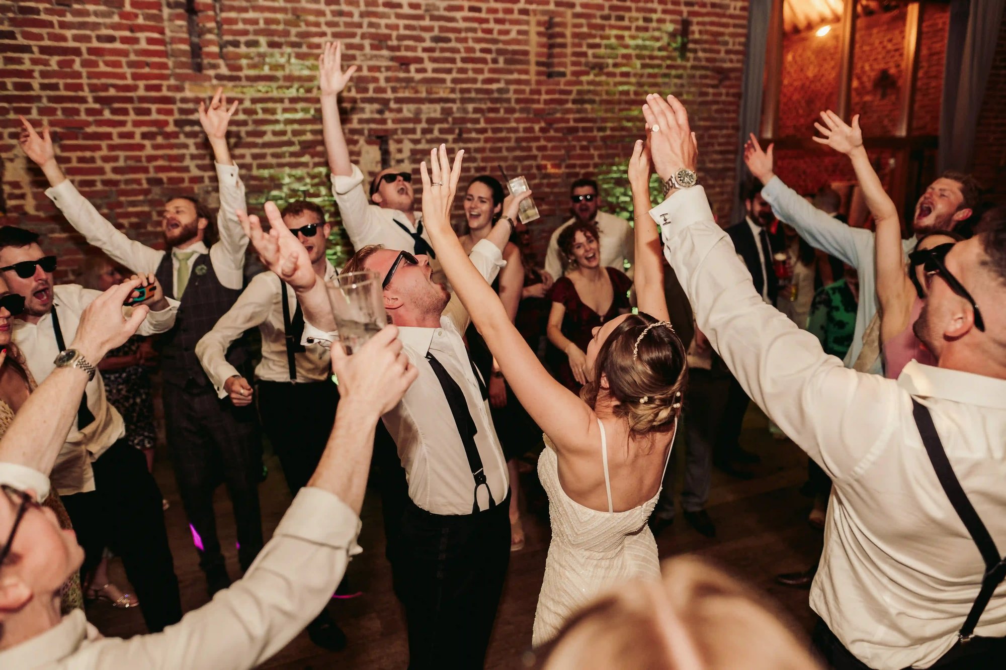 Couple and their guests dancing in the barn at Copdock Hall