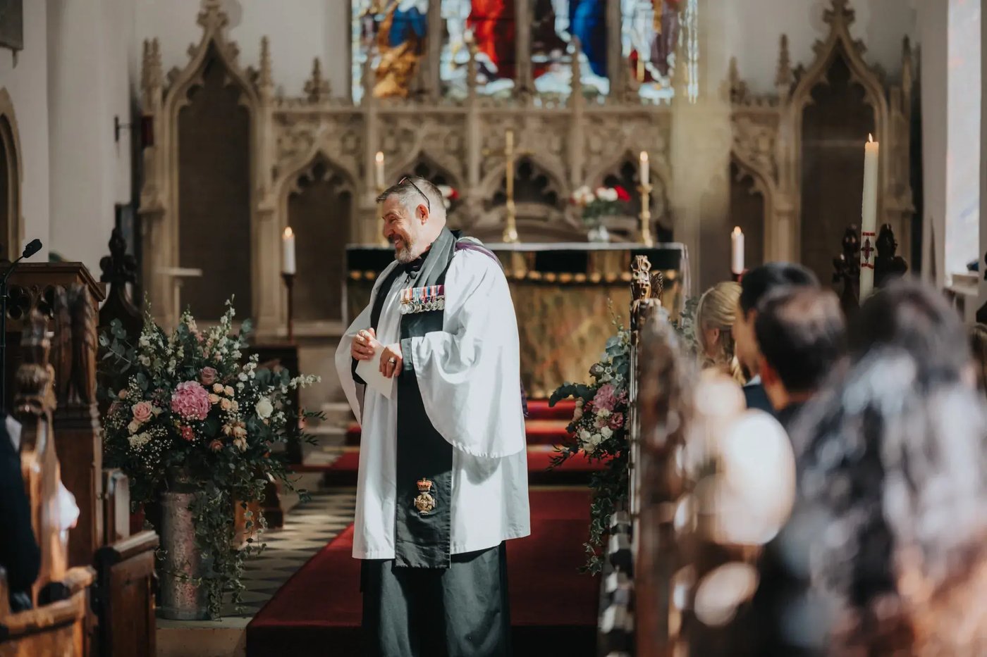 Priest speaking with guests in the church at Copdock Hall