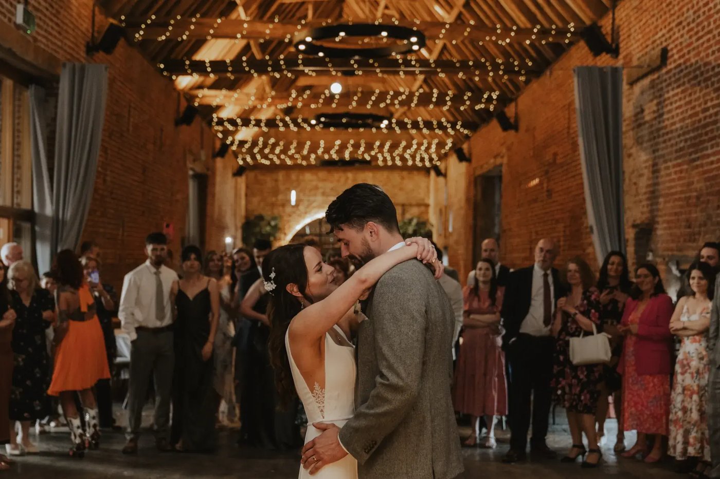 Couple embracing in first dance in barn at Copdock Hall