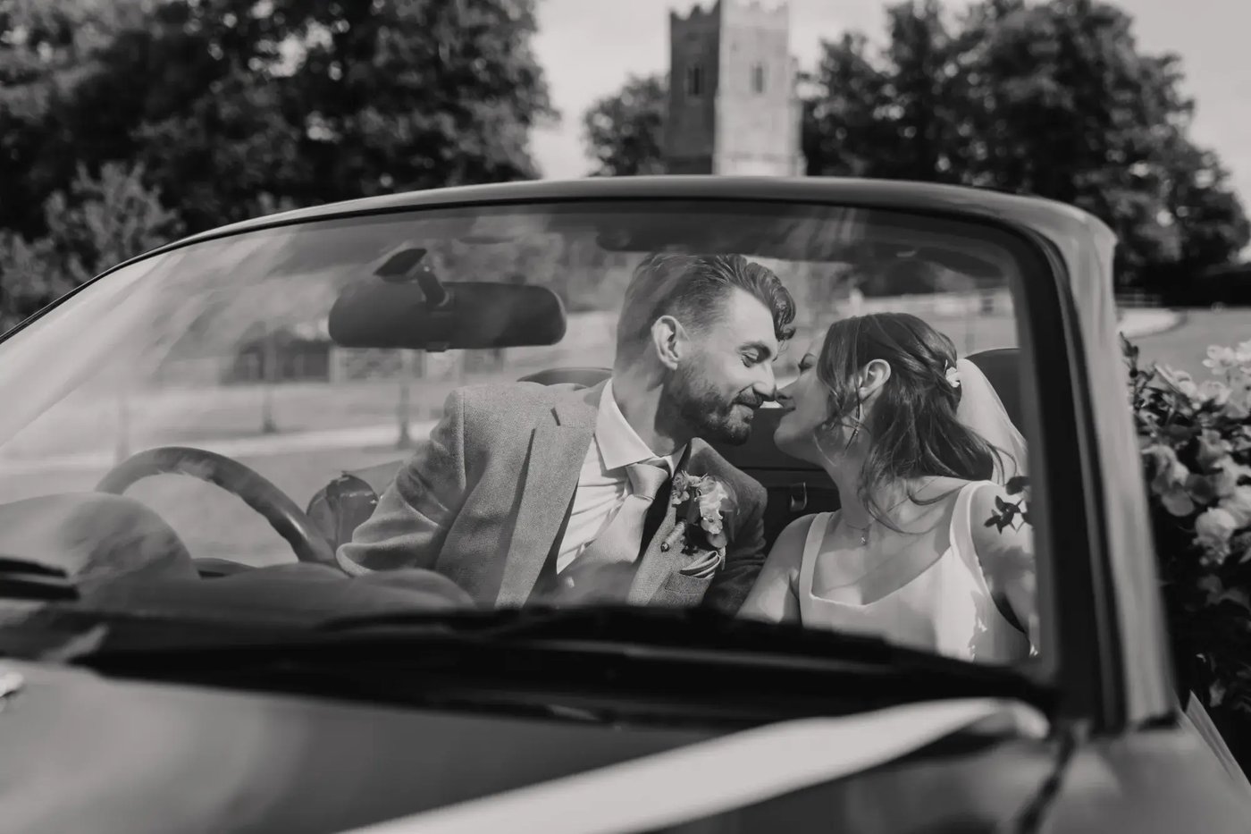Couple kissing in car after their wedding at Copdock Hall