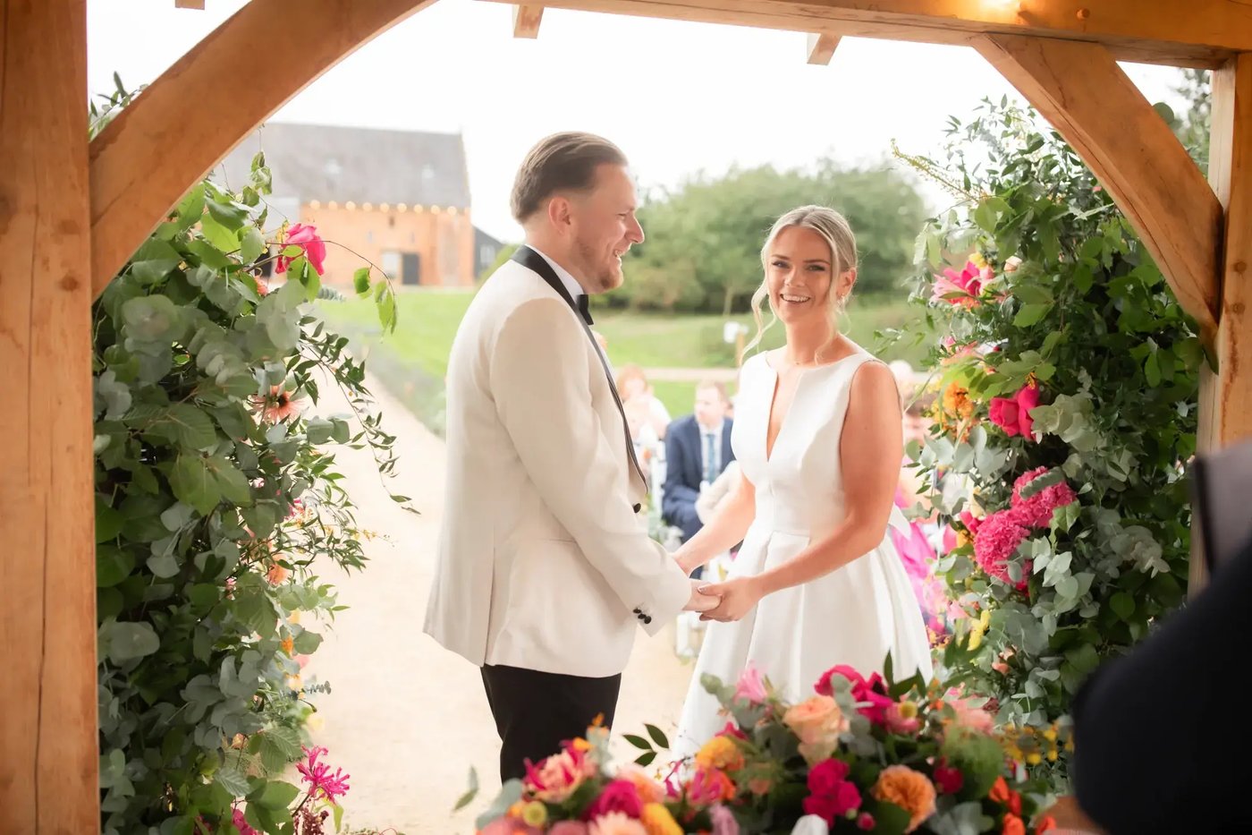 Couple being wed in outdoor ceremony at Copdock Hall