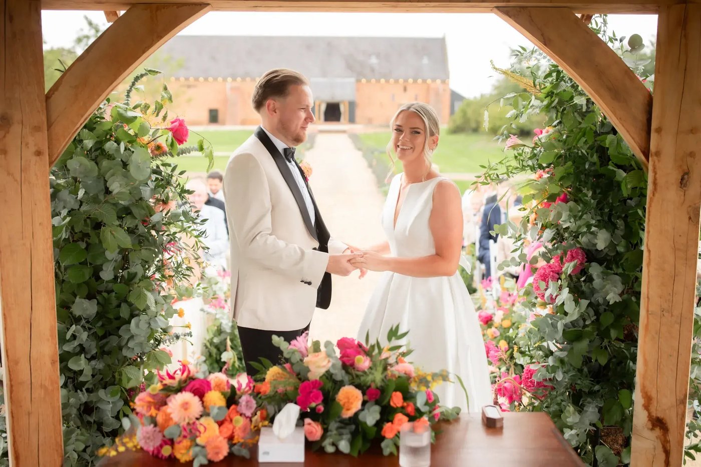 Couple being wed in outdoor ceremony space at Copdock Hall