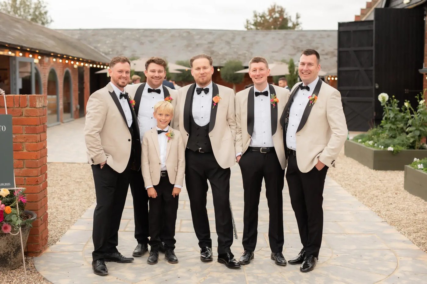 Groomsmen stood in the courtyard at Copdock Hall