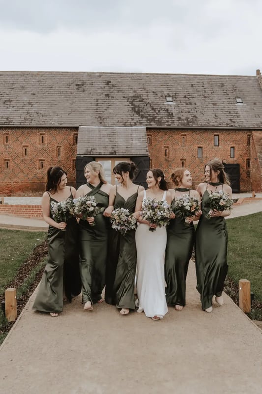 Bride and bridesmaids walking outdoors at Copdock Hall