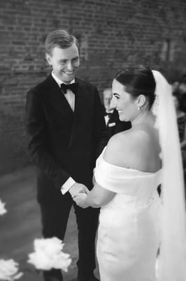 Couple mid ceremony in the barn at Copdock Hall