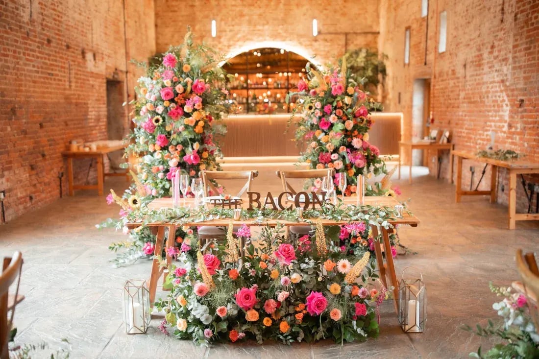 Copdock hall indoor top table set up with bright florals